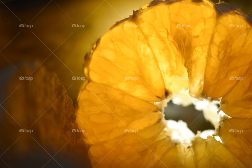 Macro photo of fresh and juicy slice of an orange.