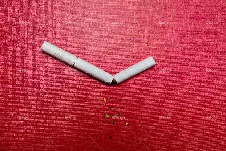 New Year's resolutions to quit smoking. Broken cigarette.
