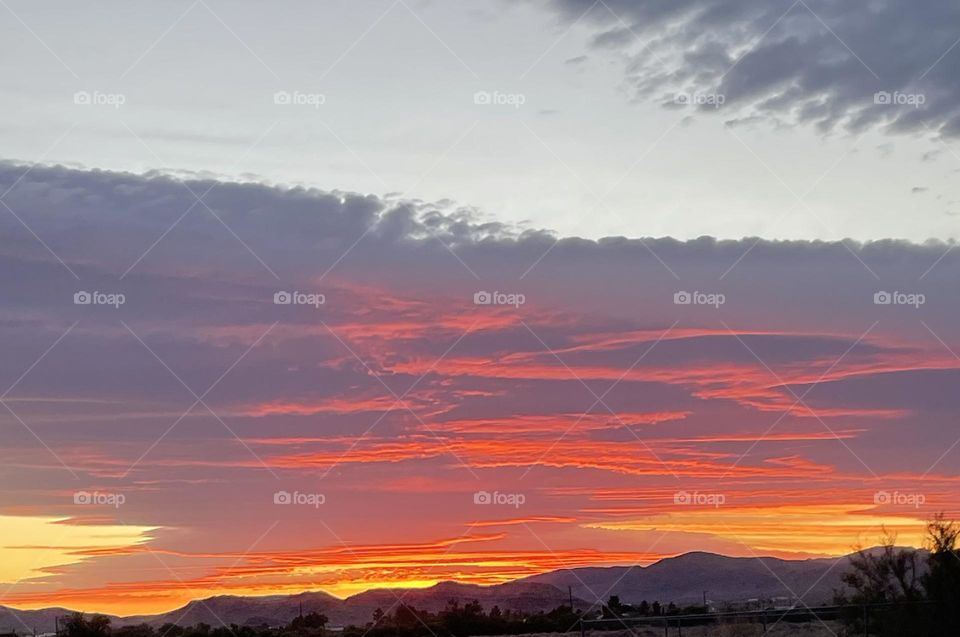 A gorgeous sunset with mountains below!
