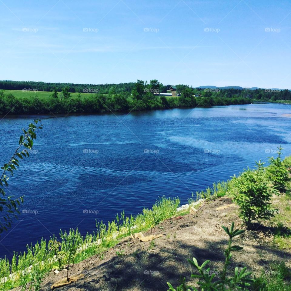 Stop alongside a river in Quebec’s countryside on a beautiful sunny summer day.