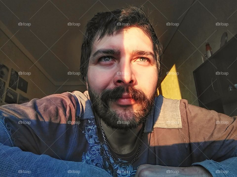 portrait of a bearded man in a room