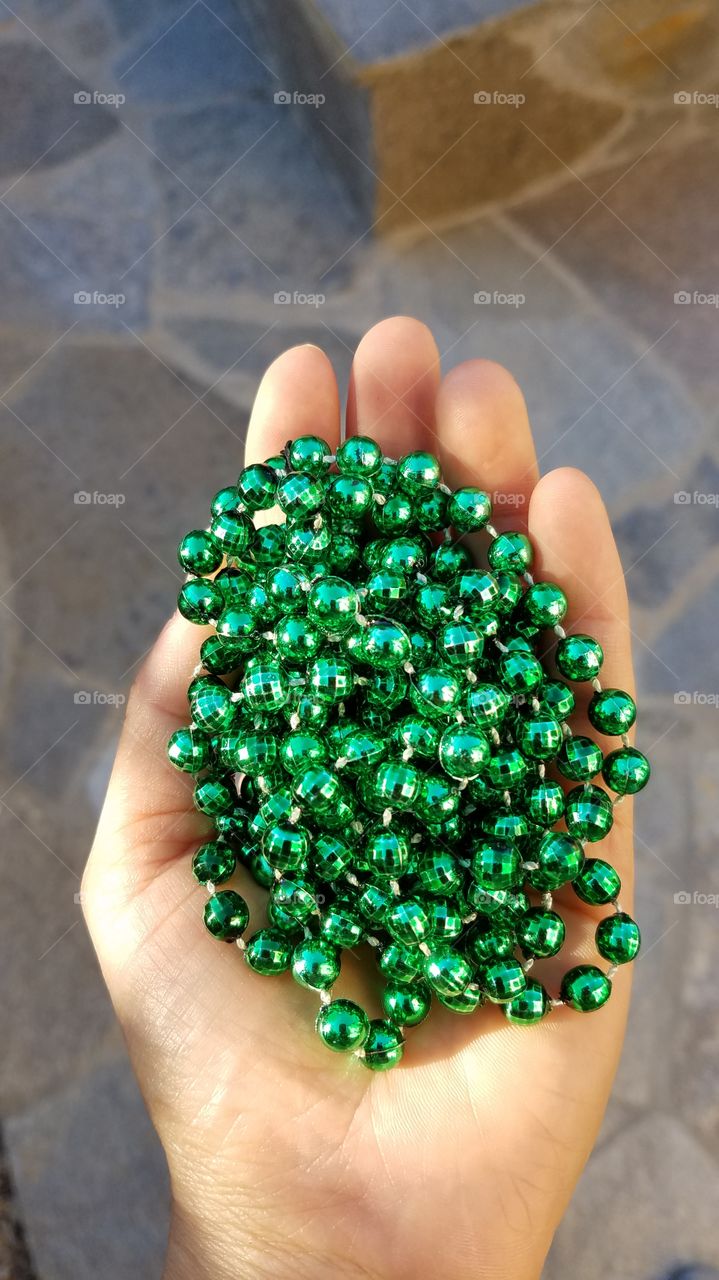 Holding Mardi Gras beads