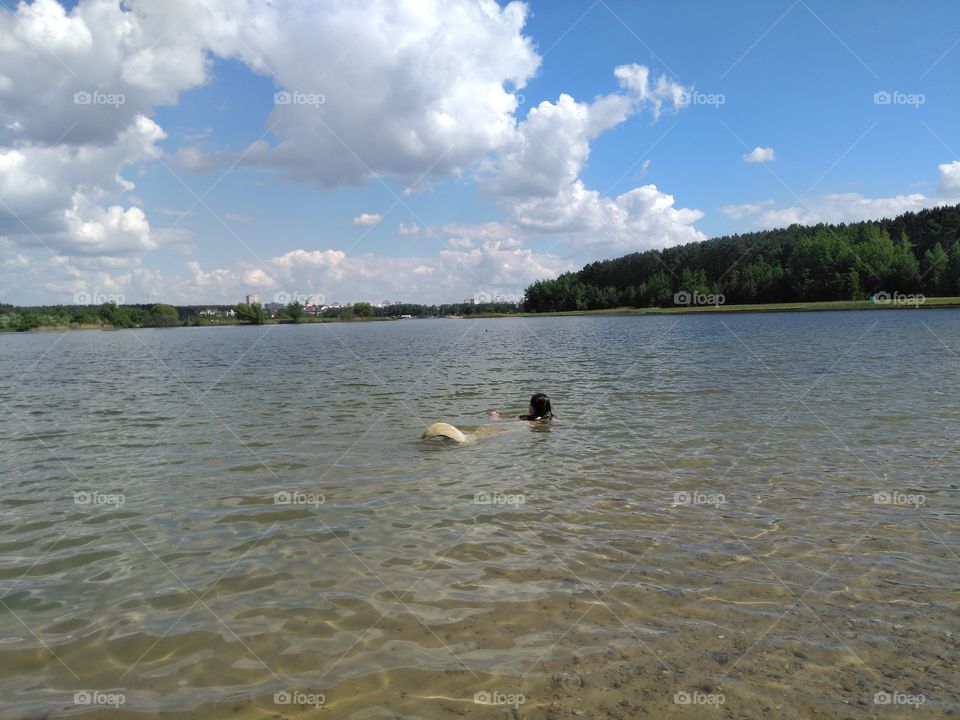 girl swimming in the water  lake summer landscape