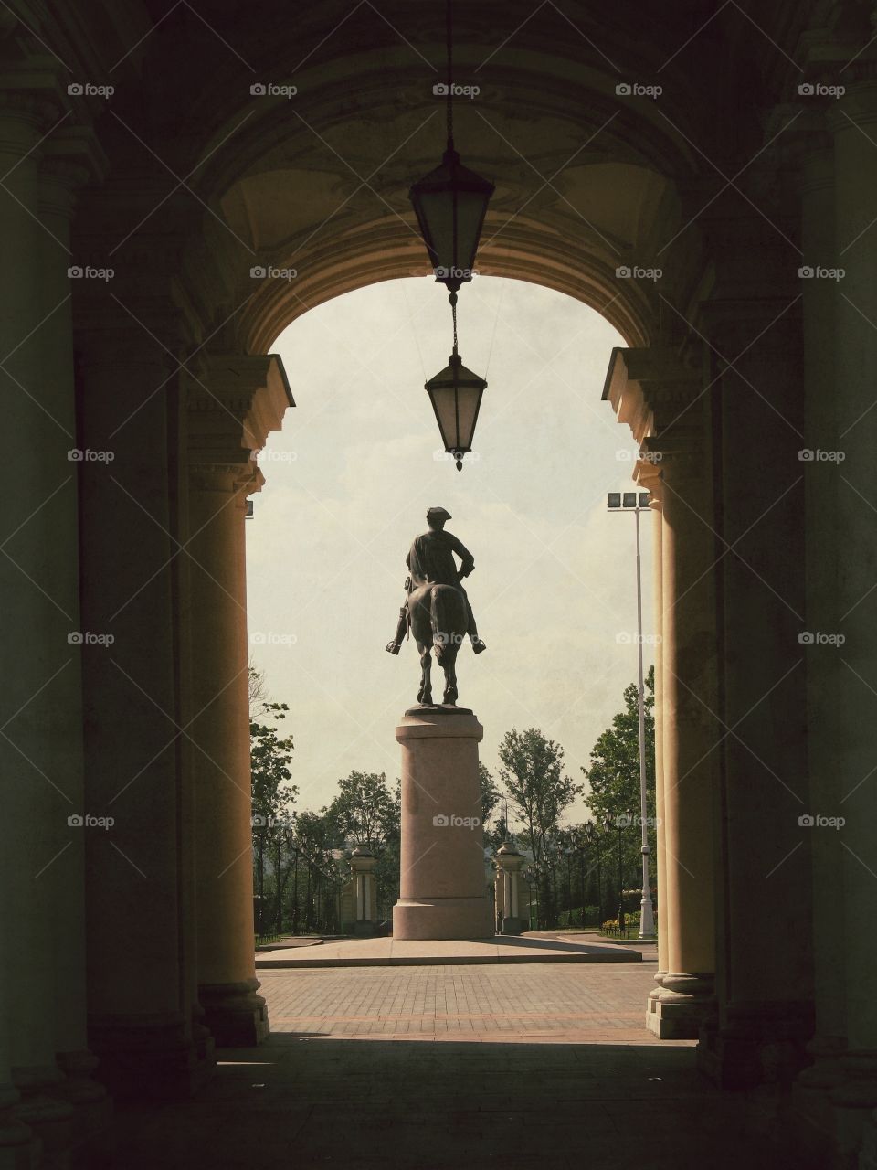 Tunnel made of columns with a view on the sculpture in Saint-Petersburg, Russia