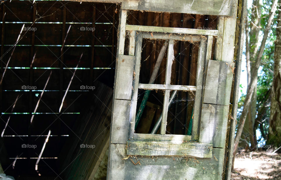 Vintage old wood cabin shed with glass missing from windows and no insulation rustic charm photography 