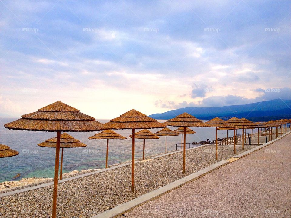 Sunshades on beach against sky