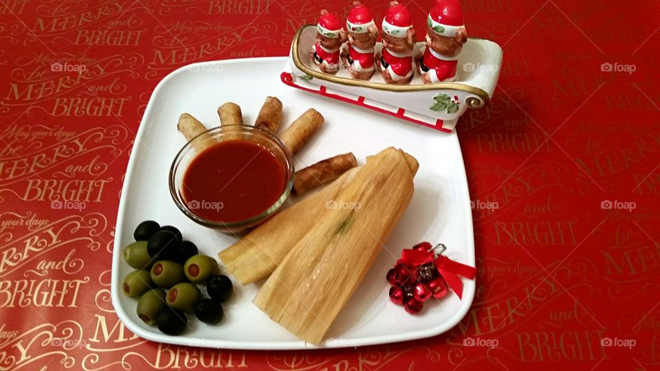 Homemade Tamales and Lumpia with Red Sauce.
