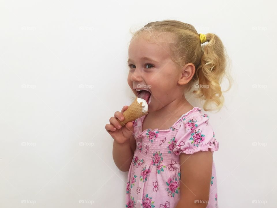 Smiling girl eating ice cream