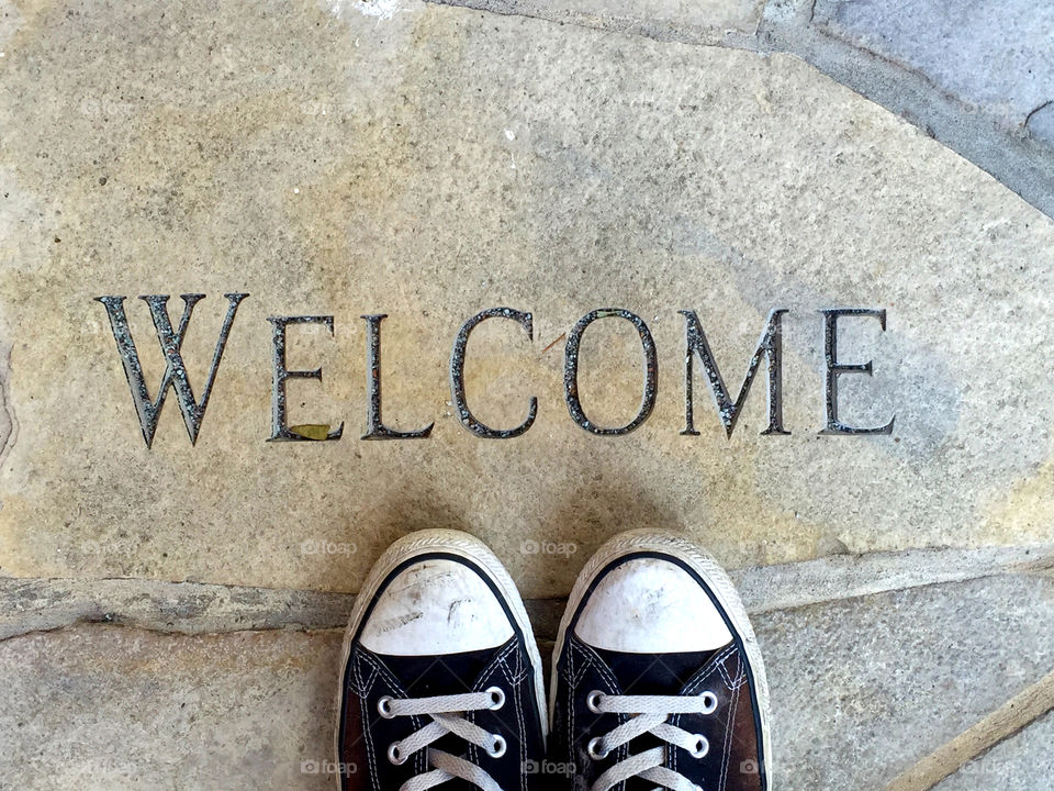 Welcome Home: welcome carved in stone with shoes