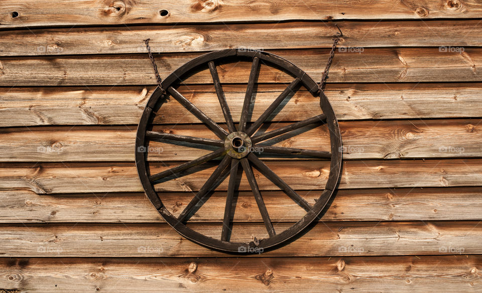 Close-up of wheel hanging on wood
