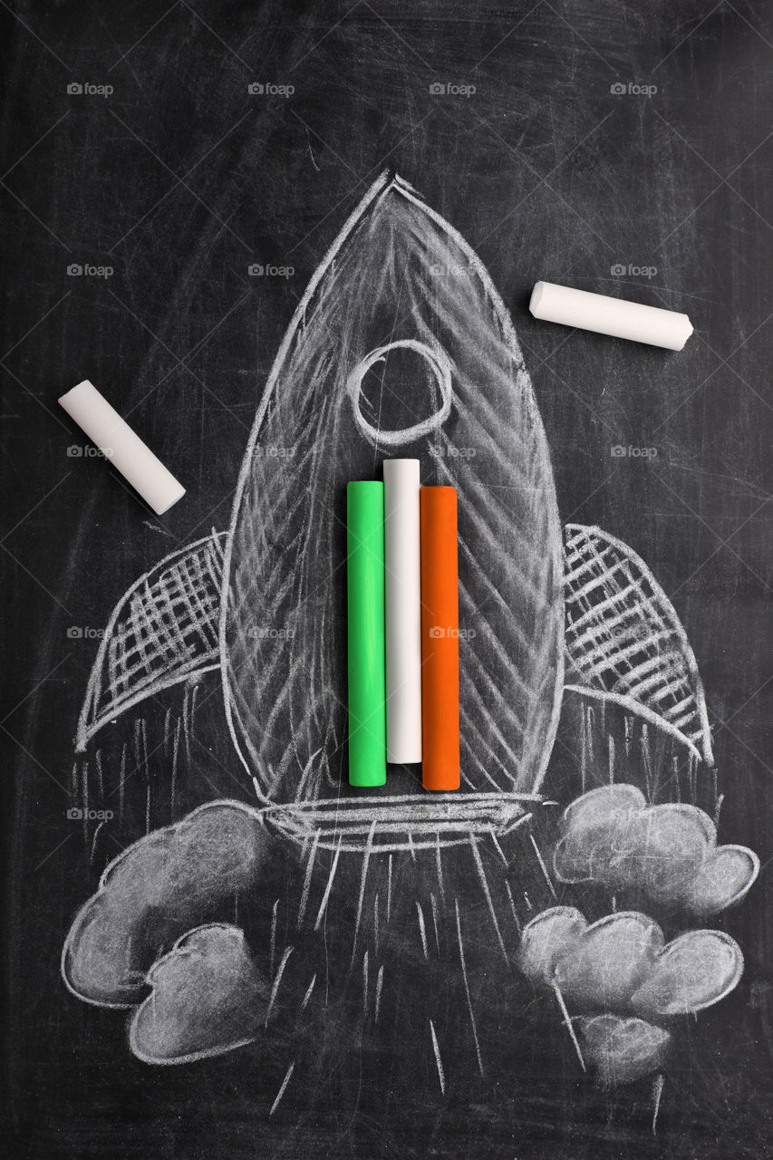 Education takes you places. India flag on chalks with a rocket drawn on black board