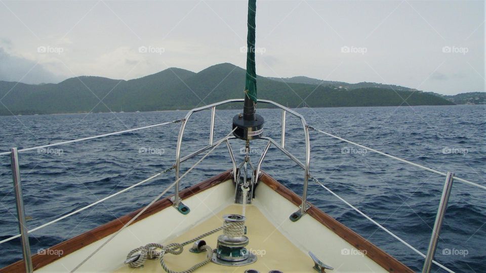 Sailing across Caribbean Virgin Islands on a hazy summer morning on calm seas