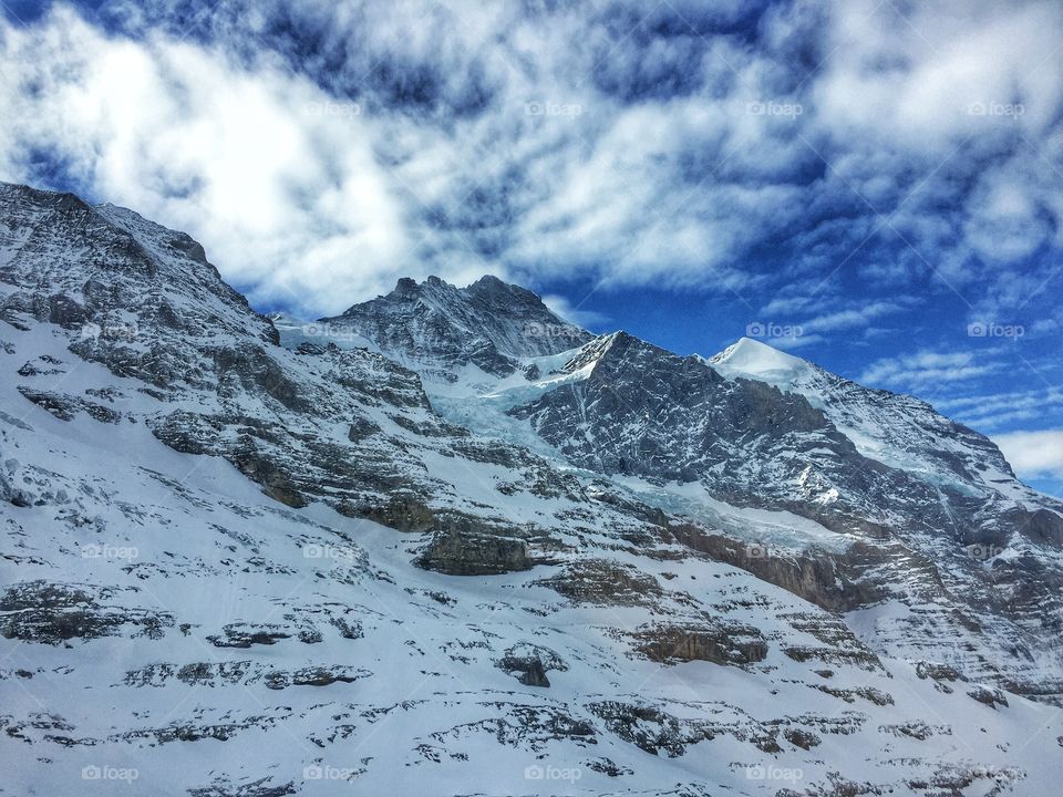 Snowcapped mountain against blue sky