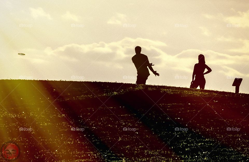 Frisbee Golf. Took this backlit photo on a frisbee golf course in Grand Rapids, Michigan. This couple was teeing off. 