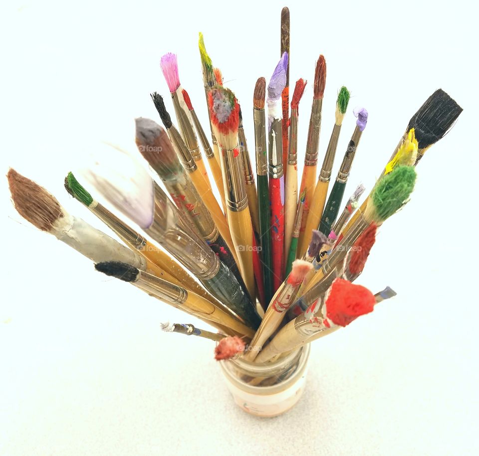 Paintbrushes of different sizes in bottle
