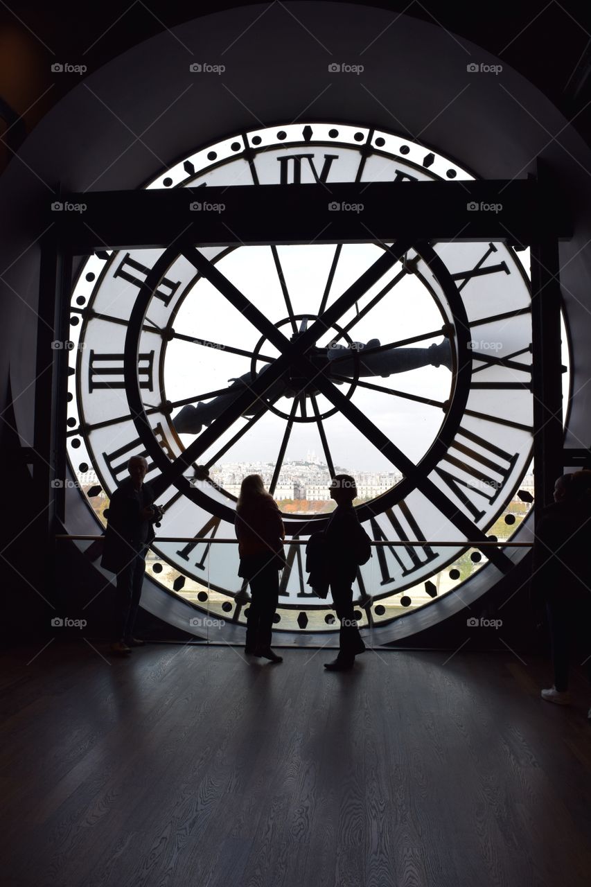 People look out of a clock at the Museum d'Orsay in Paris, France. October 2016.