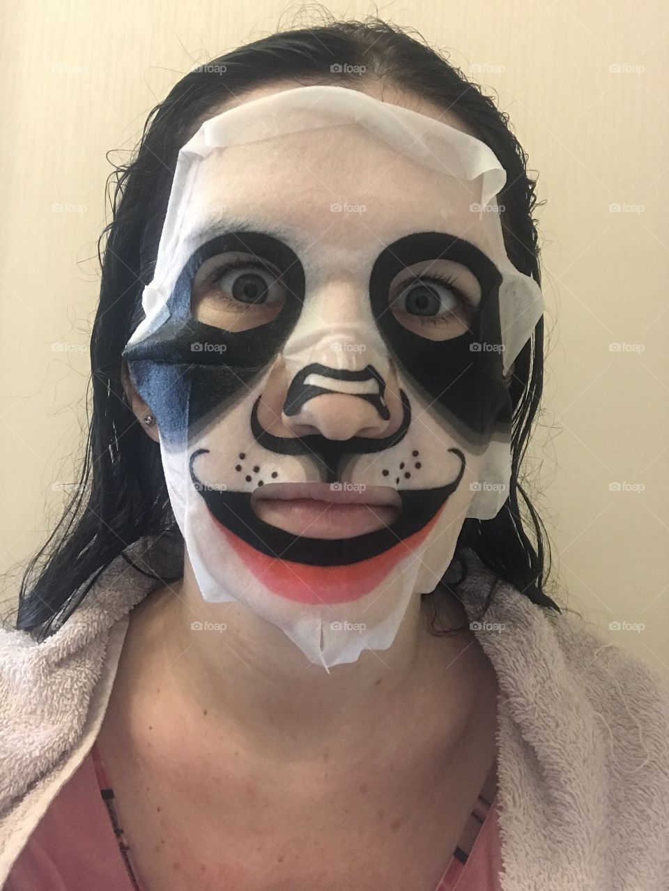 Cute girl with cosmetic mask on her face