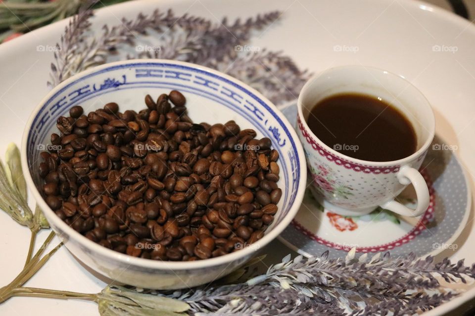 A cup of coffee and coffee beans