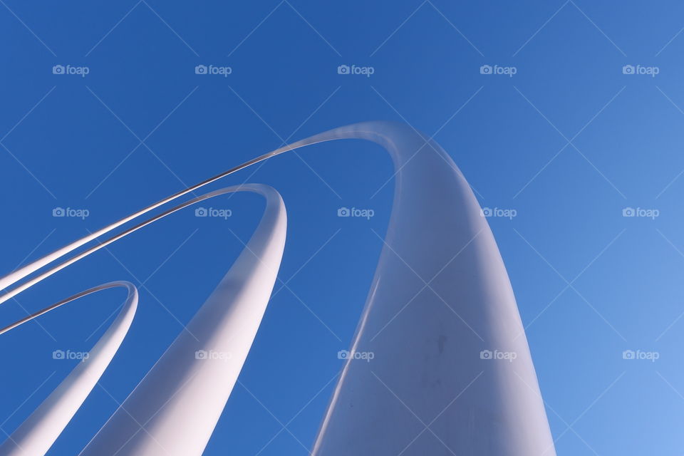 Artwork in Elizabeth Quay, Perth, Western Australia. Blue sky and white sculpture create contrast between light and shadow.