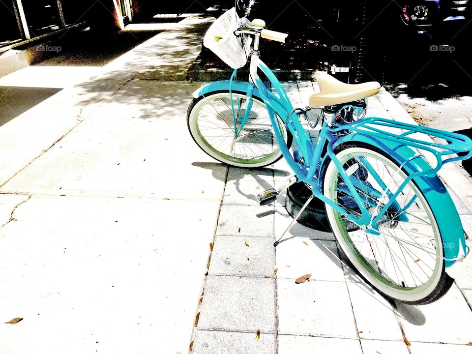 Blue bike. A blue bicycle on a sidewalk 