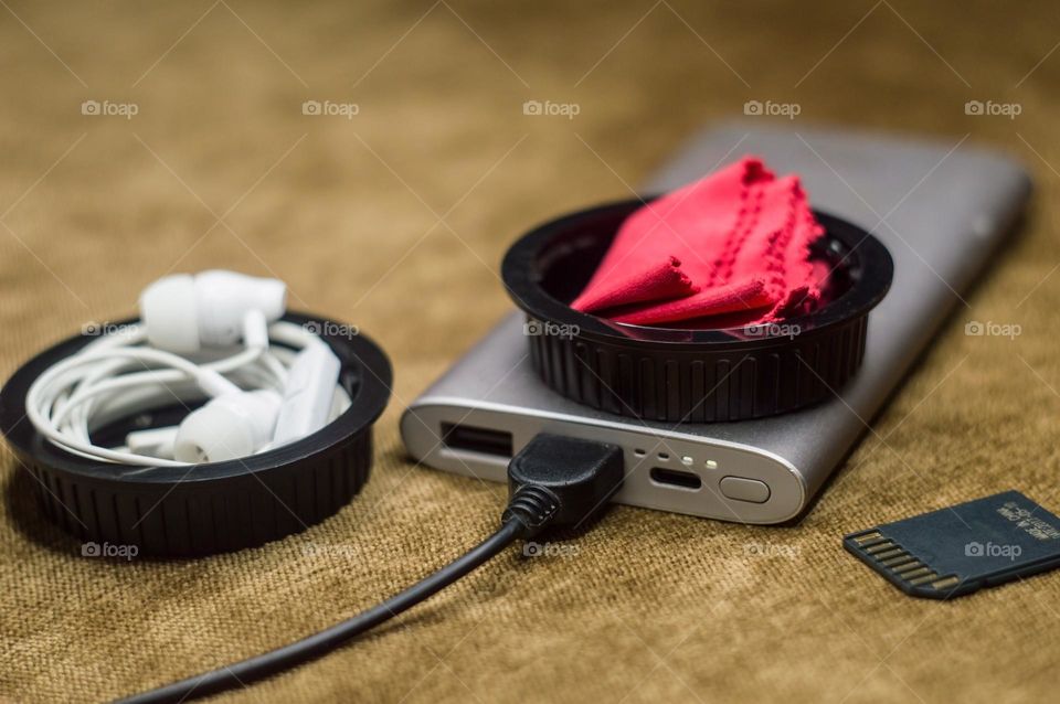 My constant kit wherever I go is a power bank headphone flash drive lens wipe.