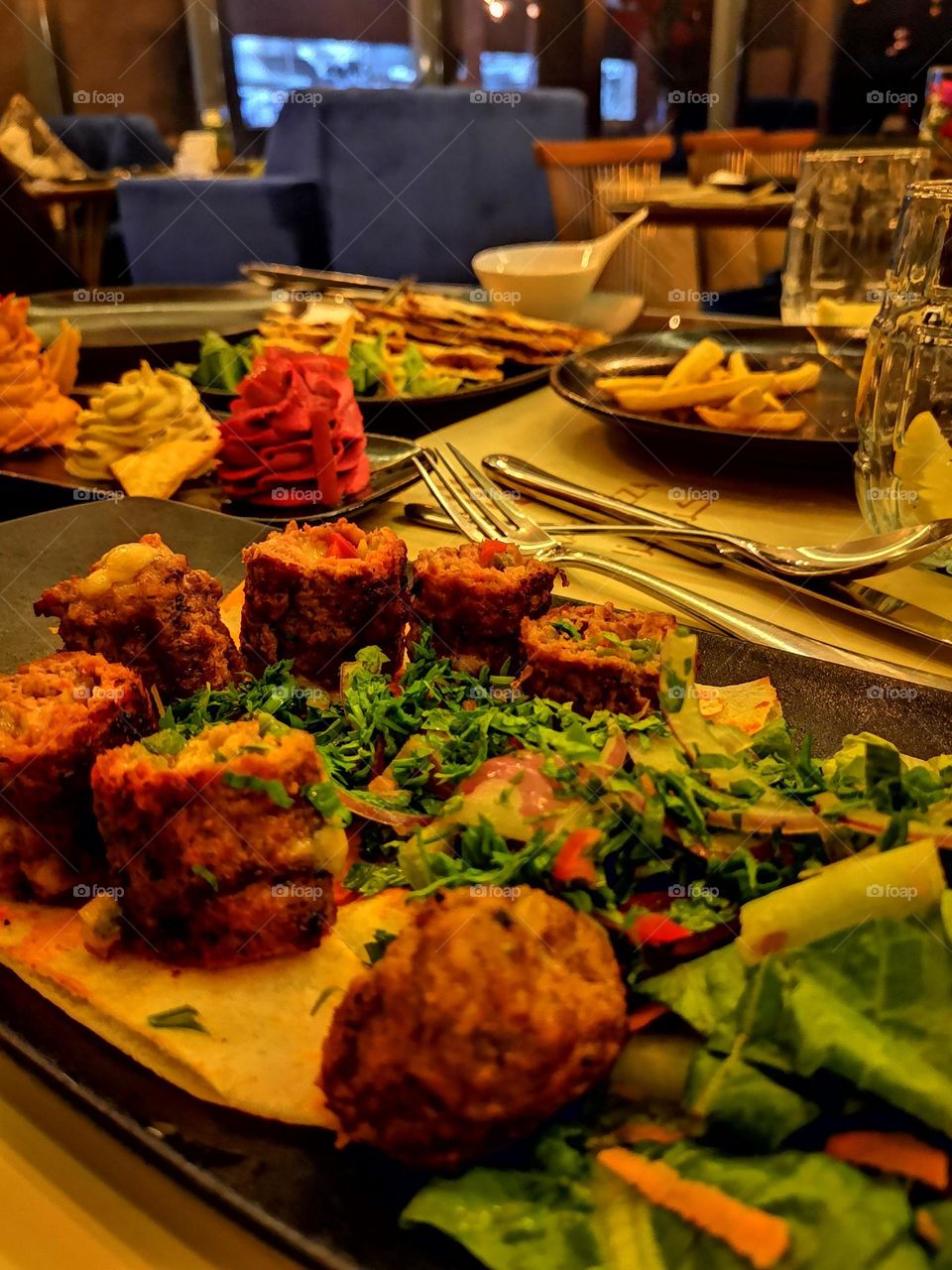 Dinner dishes of grills, stuffed with cheese, salads and French fries