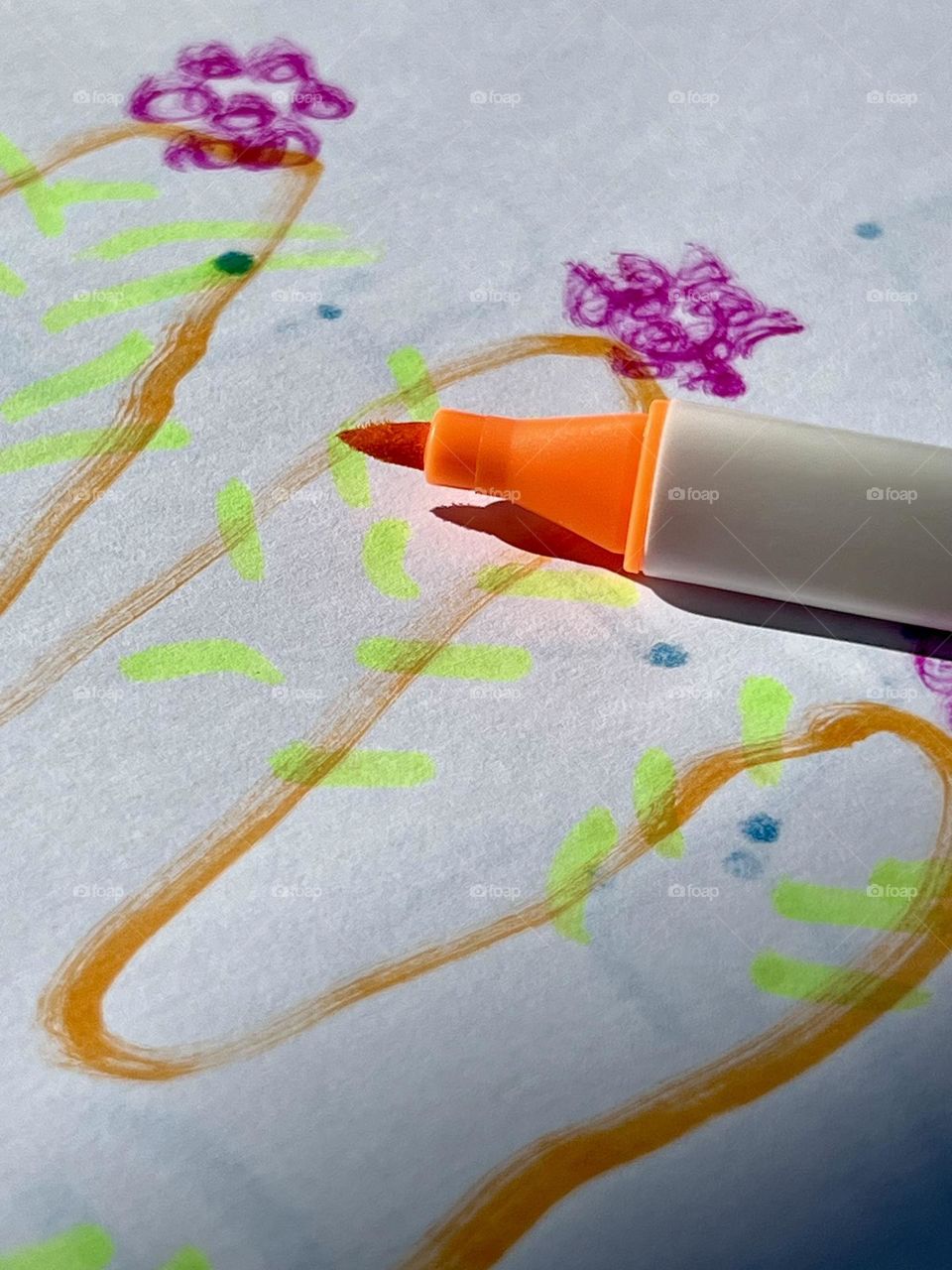 Orange marker on children's drawing
