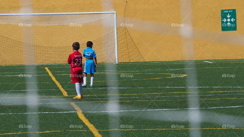 Soccer game field match. Young kids playing soccer