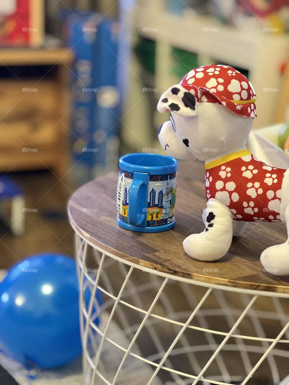 Blue cap and toy dog on the table 