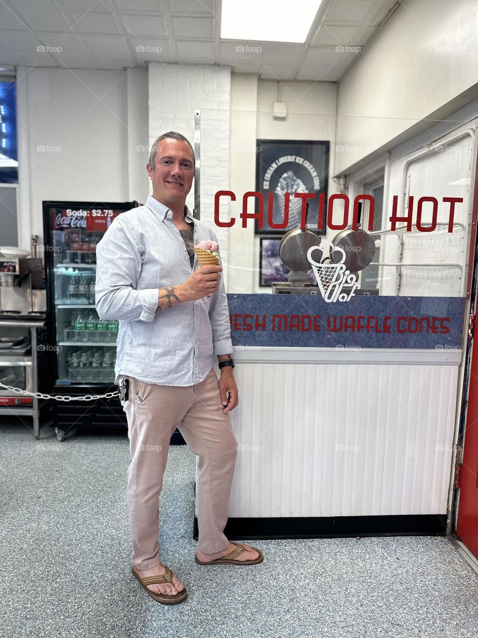 Dad poses by funny sign, father being funny, eating ice cream with Dad, caution hot sign, funny Dad antics 