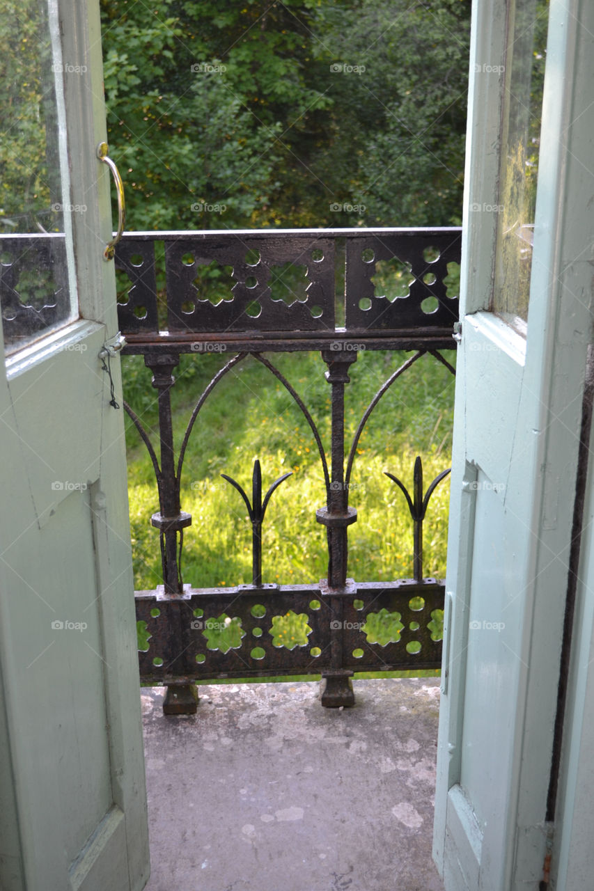 Ornate Wrought Iron Railing through Green Gazebo Doors