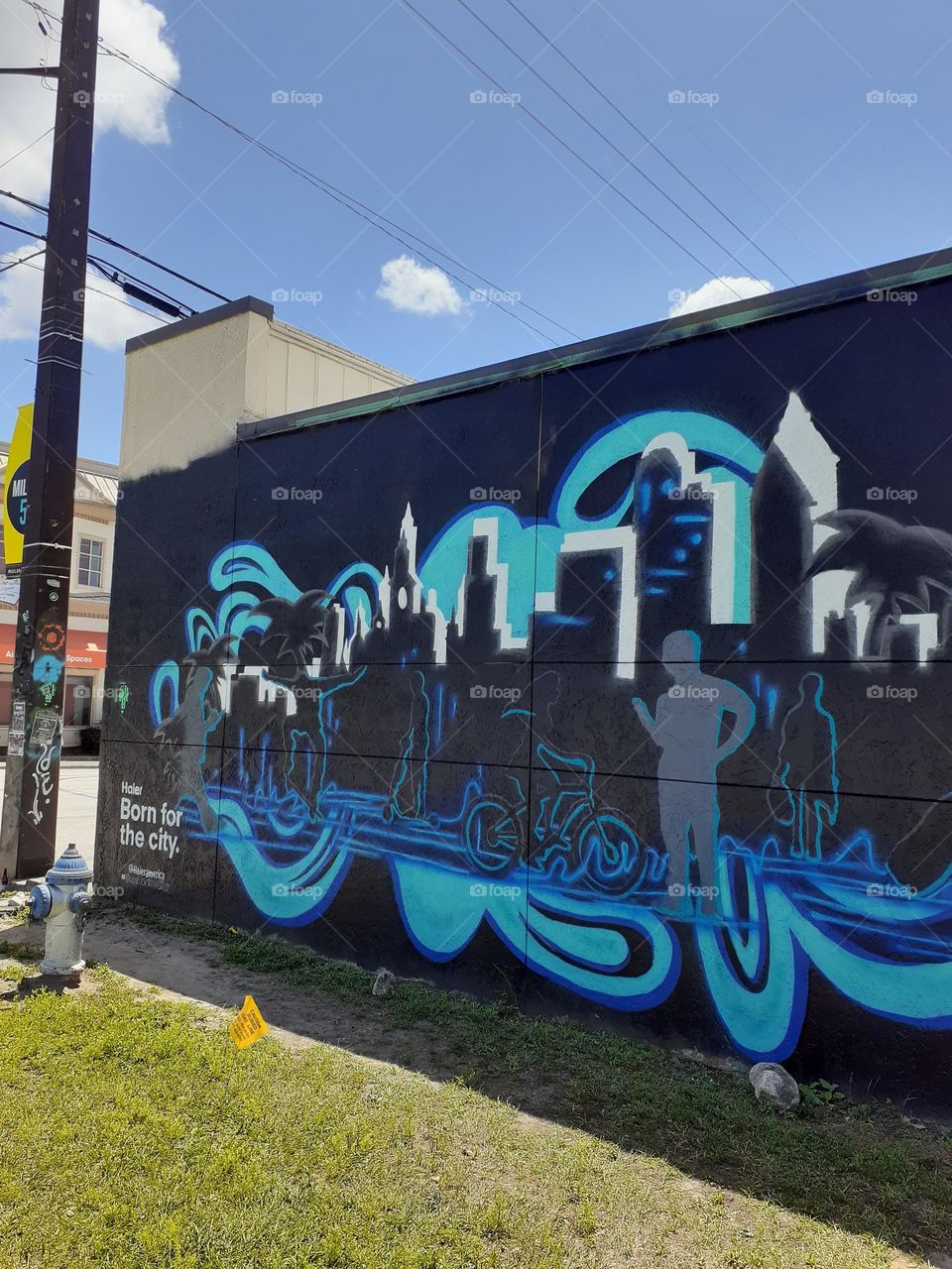 A colorful mural using different shades of blue is painted on a building in downtown Orlando.