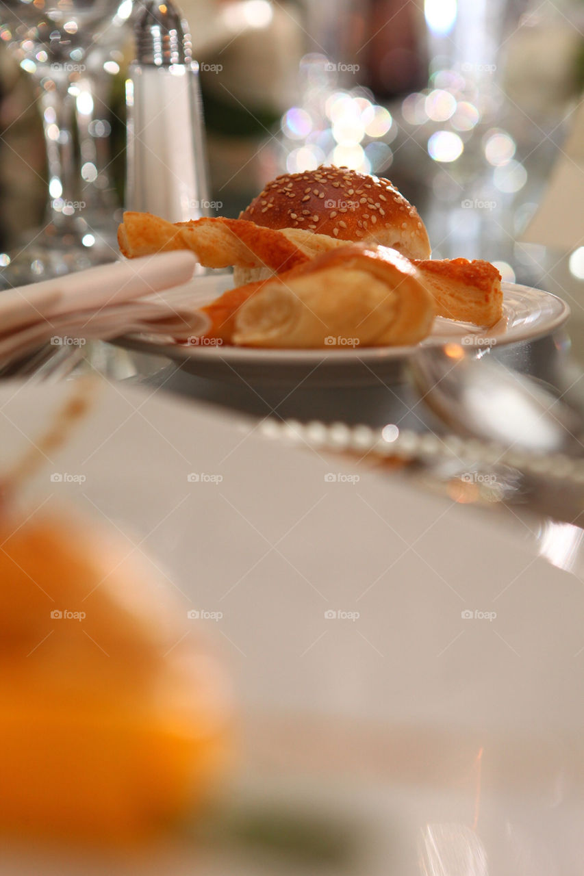 Bowl of fresh petite bread pieces served on fancy table for diner