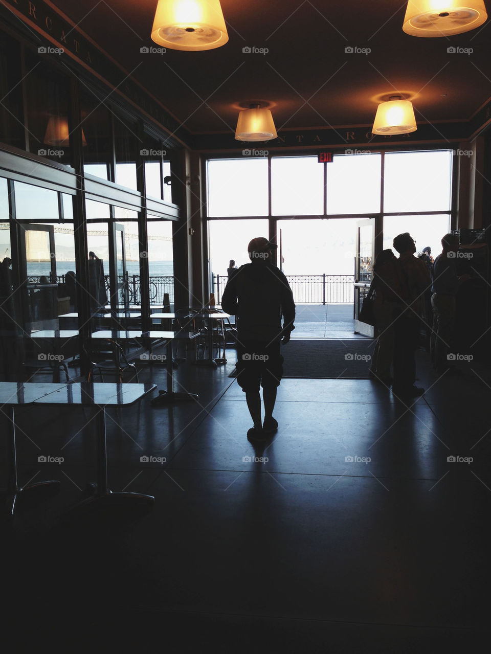 MAN WALKING INTO OUTSIDE SUNLIGHT