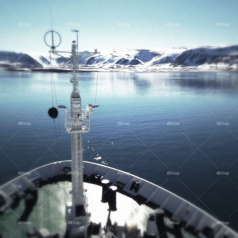 An expedition ship hangs around a bay in Spitsbergen, Svalbard.