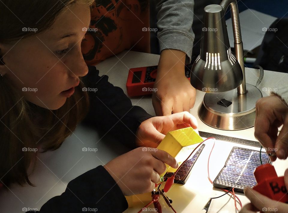 Girls In Science. Young Girl Building An Electrical Circuit For A School Science Project
