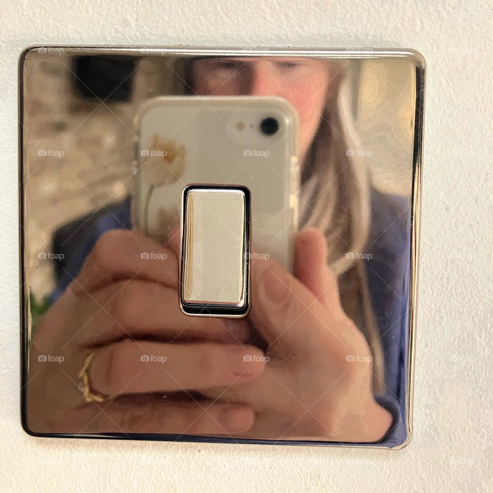 Shooting a selfie from a polished light switch 