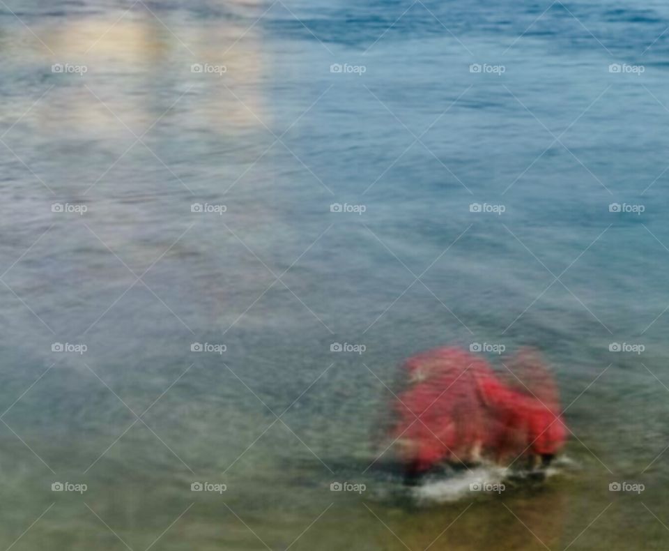 a muslim woman taking a sea bath