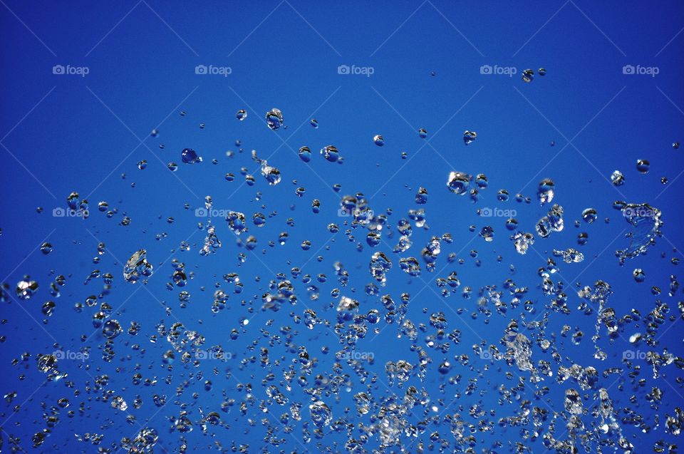 water in motion - water drops on the blue sky background