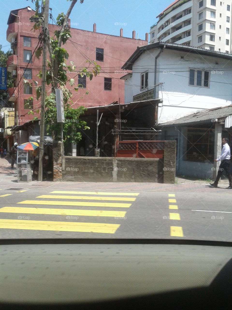 pedestrian crossing on the road.buildings are arounded