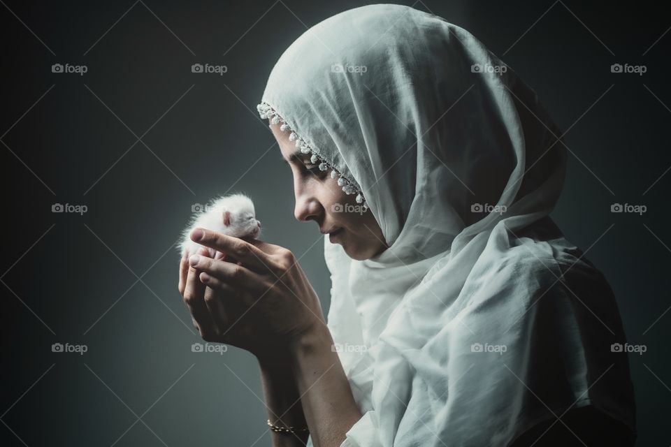 woman holding a baby cat