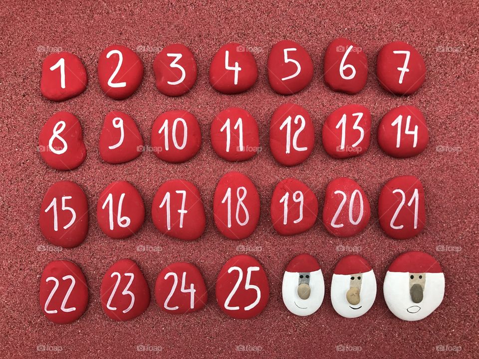 Christmas calendar with colored stones  and Santa Clauses