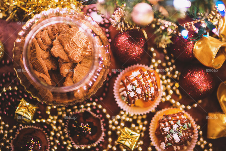Top view of jar with cookies, sweets and christmas decoration