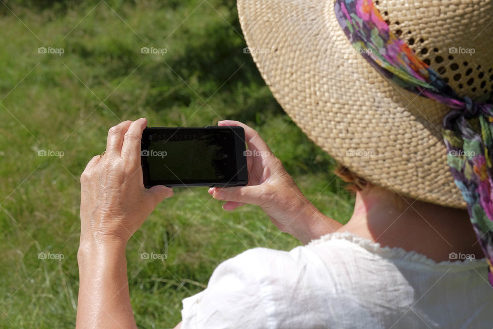 Phone. Camera phone Tourist taking a picture with a smartphone cell phone mobile phone camera 