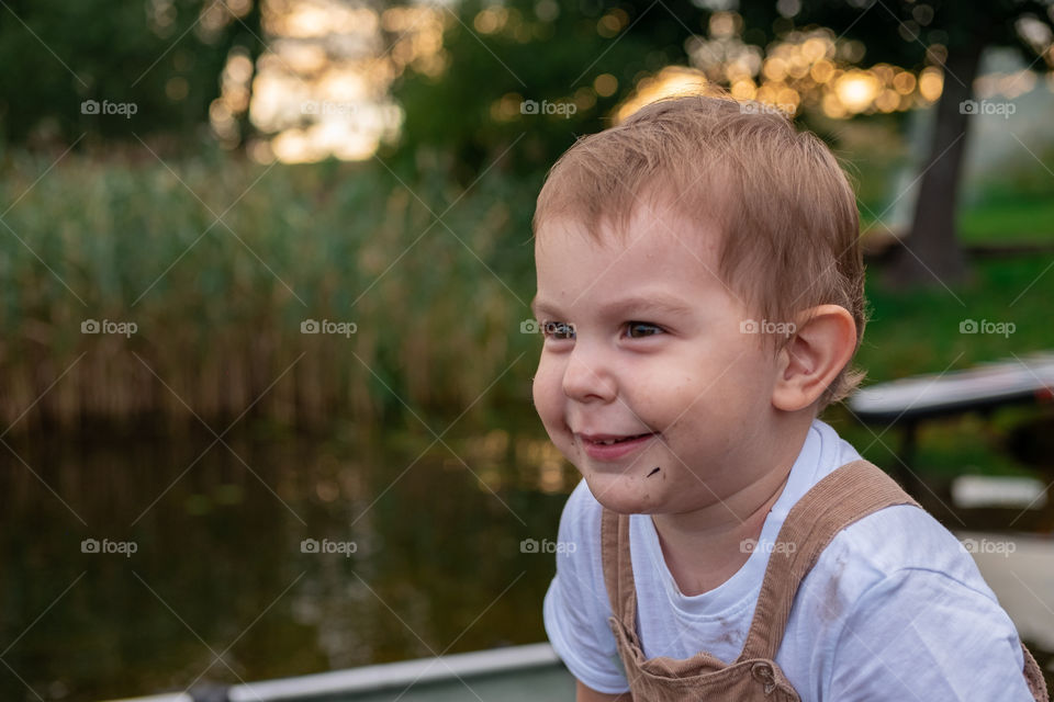 Little toddler boy portrait on sunset hour