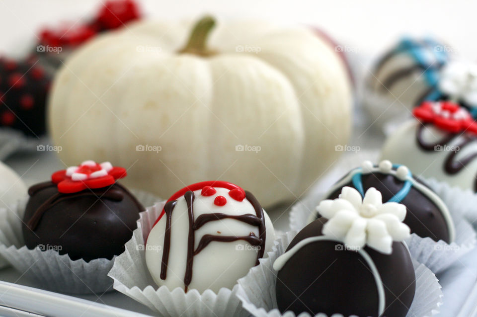 Cake pops and a small decorative white pumpkin