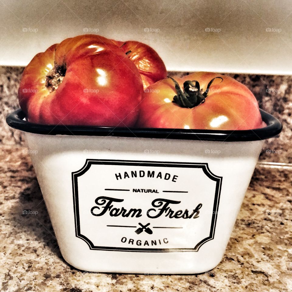 Fresh picked Heirloom tomatoes in a container 