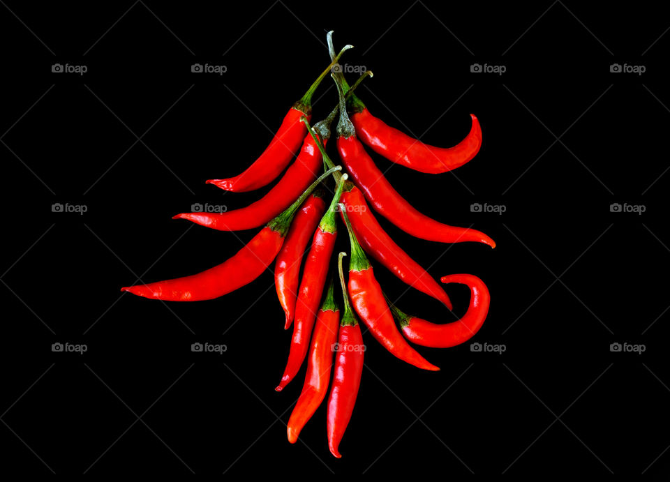 Red hot chilli pepper on black background, top view