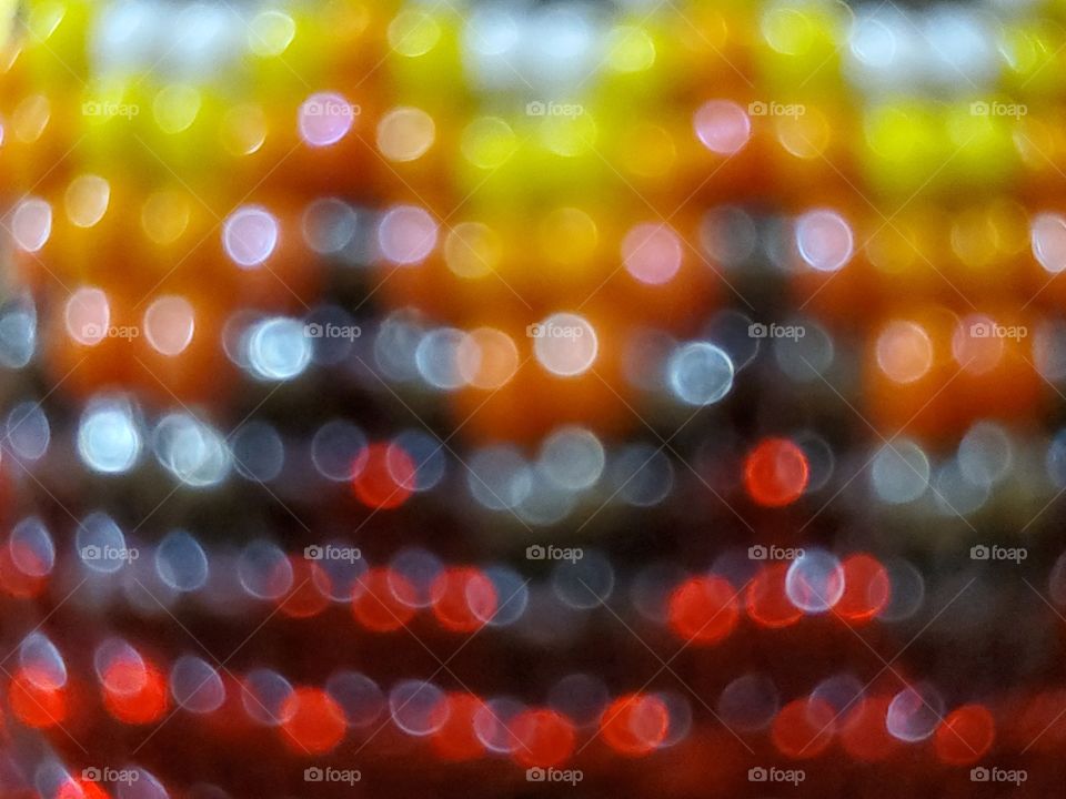 Colorful candy corn and red and black lights.  Reflective light illuminating color in a small circle texture.