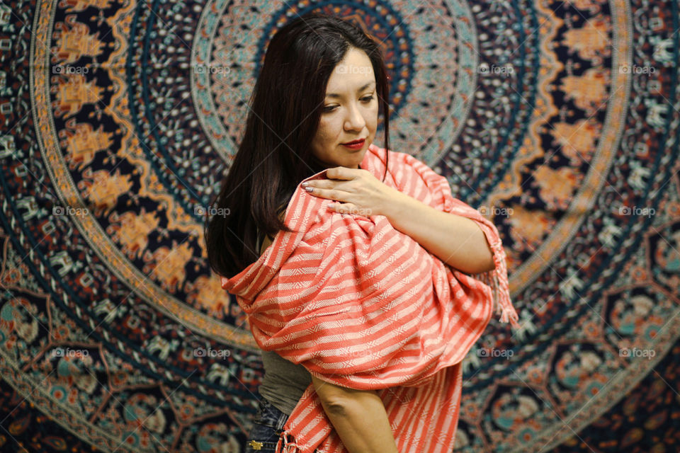 woman wearing salmon pink traditional Mexican rebozo scarf
